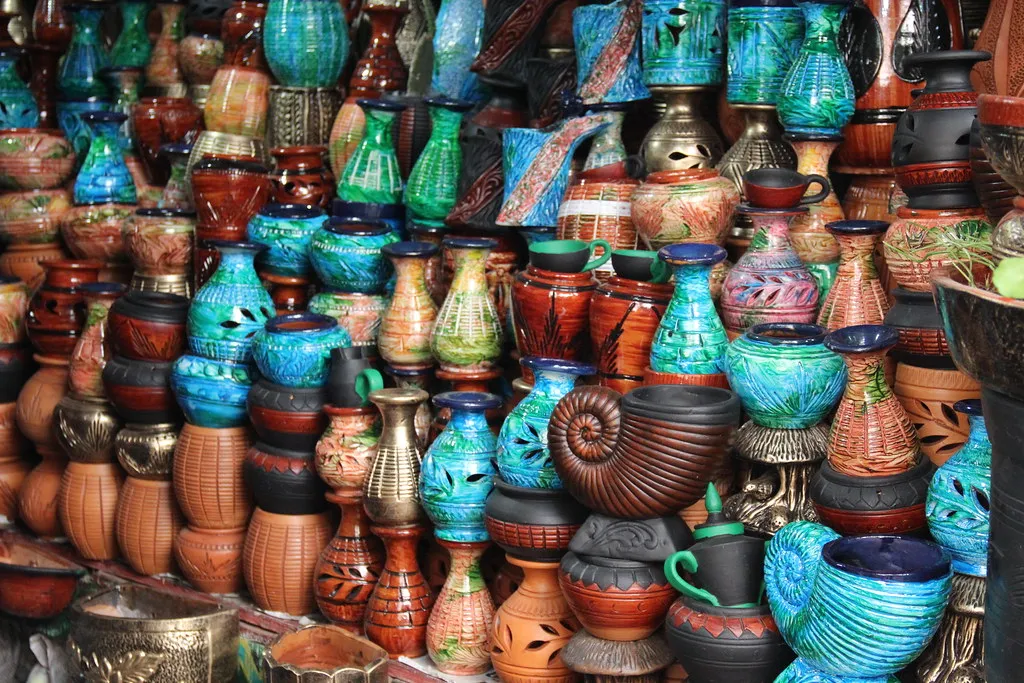 Painted clay pots stacked at a street market stall in Dhaka